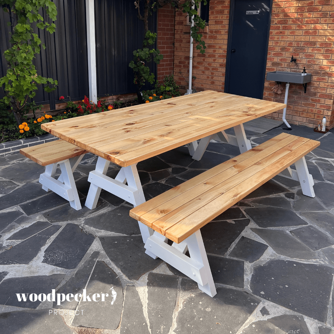 A versatile picnic table set with a smooth wooden top and benches that can be easily separated for individual use, great for picnics and parties