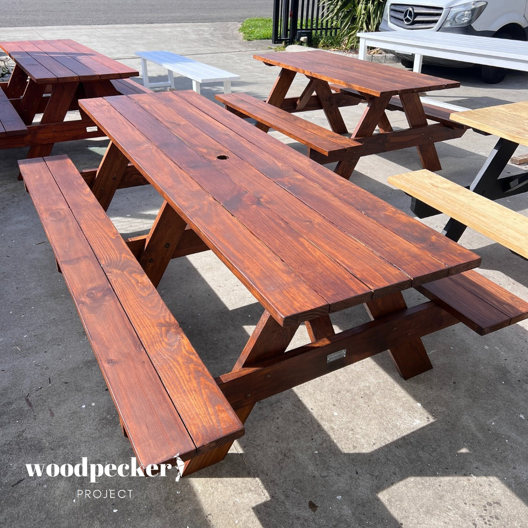 Add a touch of rustic charm to your backyard with this inviting picnic table, perfect for hosting barbecues and casual outdoor meals, providing a cozy spot for friends and family to linger