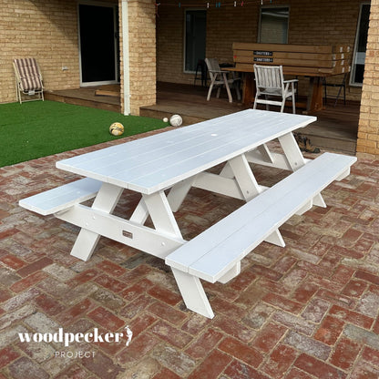 harming picnic table made from pine and hardwood, adding warmth to any outdoor space.