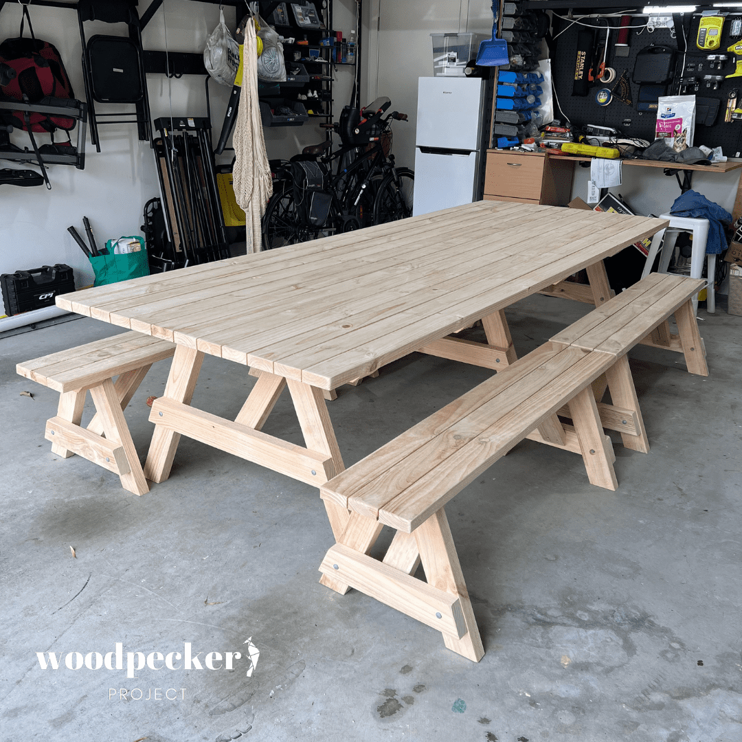 A handcrafted picnic table set with a smooth, varnished finish, providing a stylish and practical solution for outdoor dining