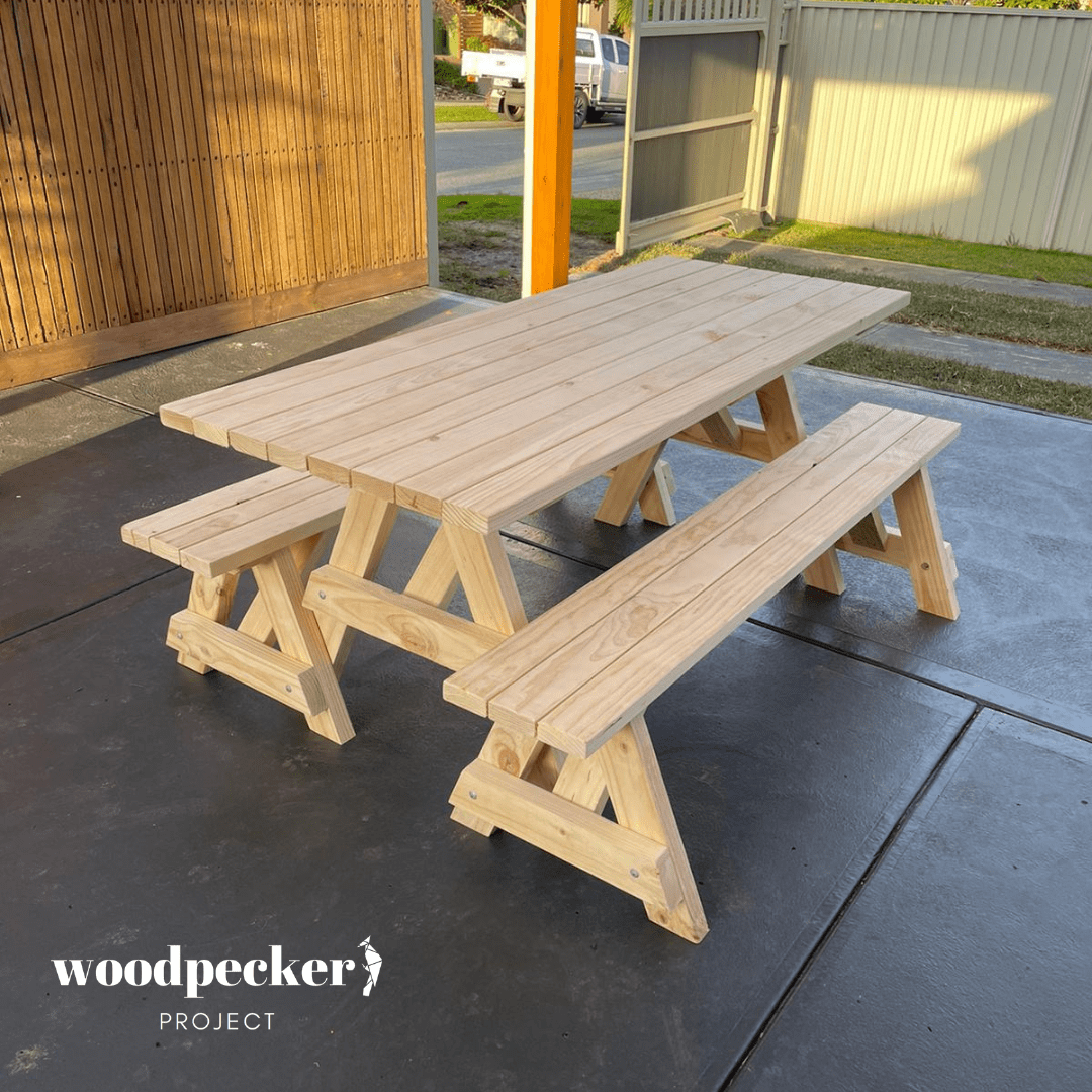 A classic picnic table set with a robust wooden table and coordinating benches, perfect for enjoying meals in your garden or patio