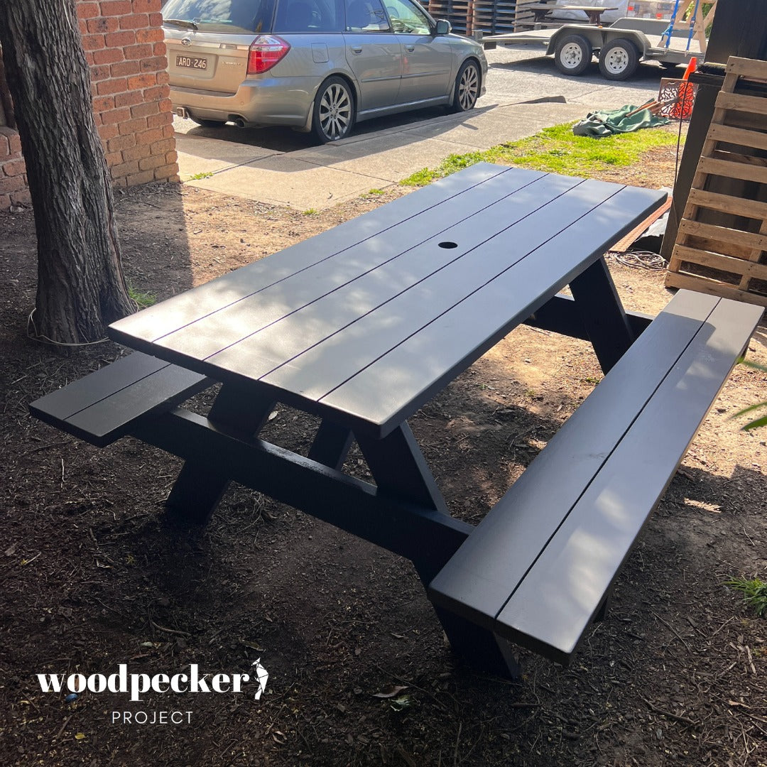 Elegant picnic table made from pine and hardwood, enhancing outdoor entertainment areas.