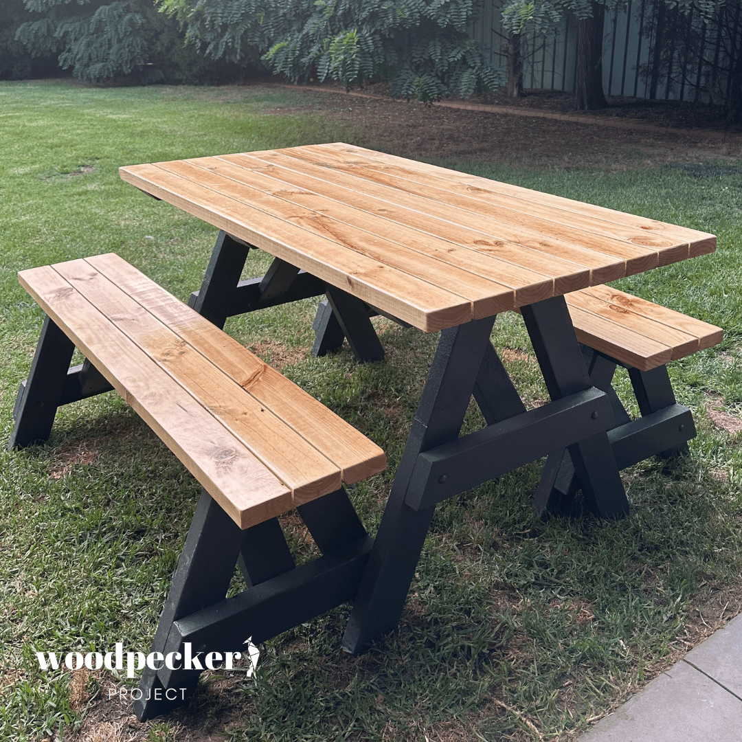 A heavy-duty picnic table set designed for durability, featuring a solid wooden table and benches that can be separated for versatility