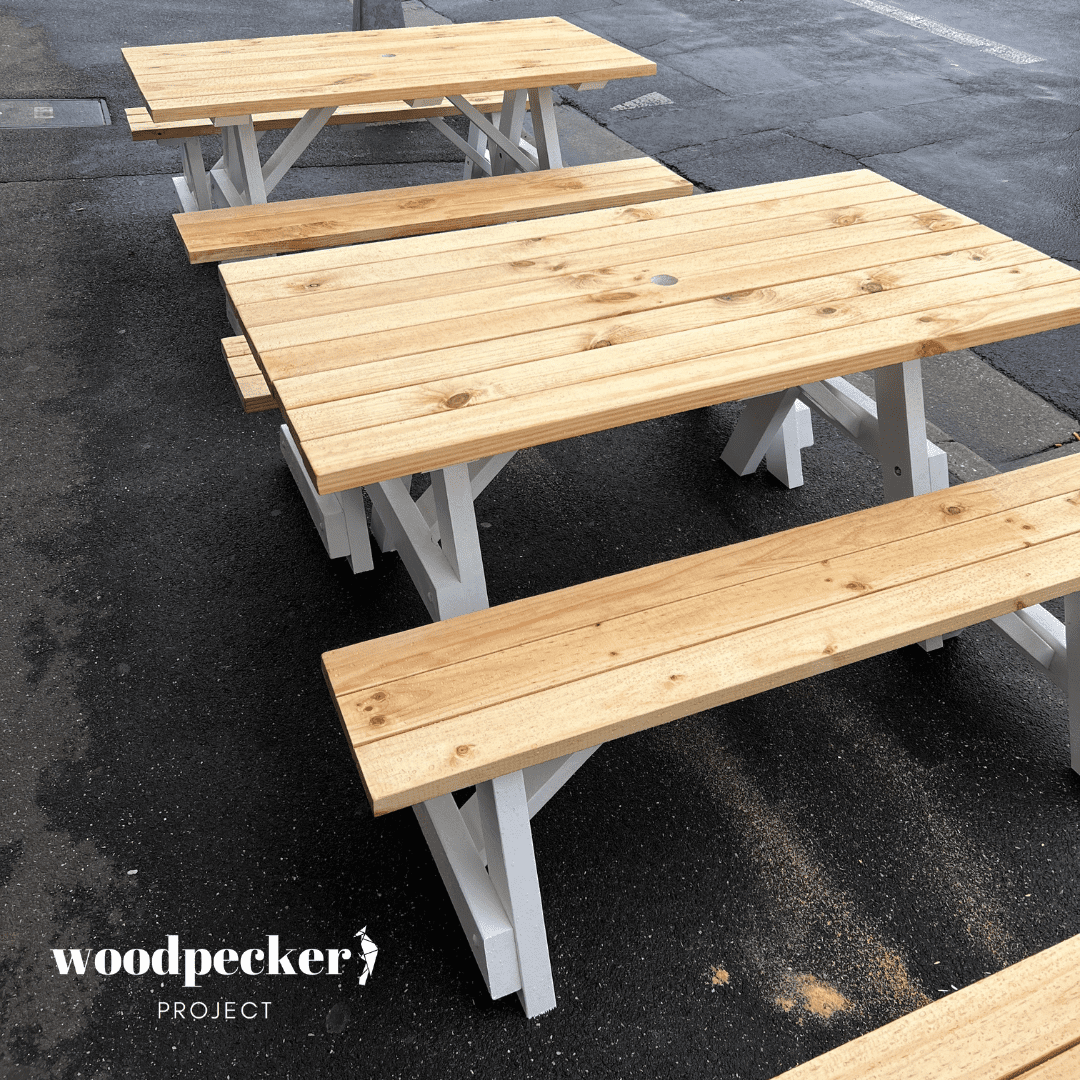 A functional picnic table set with a detachable bench design, allowing for easy transport and storage, perfect for picnics and camping trips