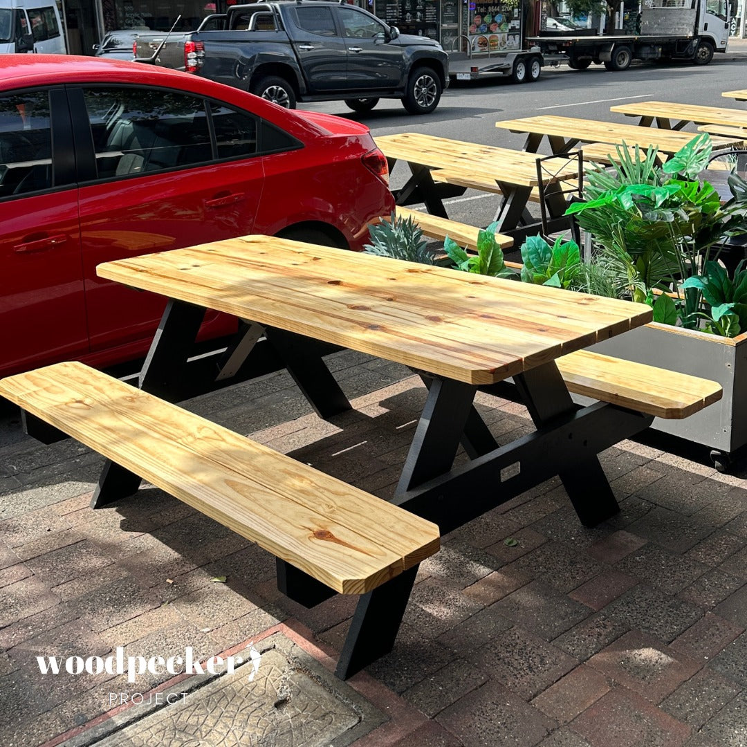 Embrace the timeless appeal of this classic picnic bench, a versatile addition to any outdoor space, ready to accommodate memorable family gatherings and joyful celebrations.