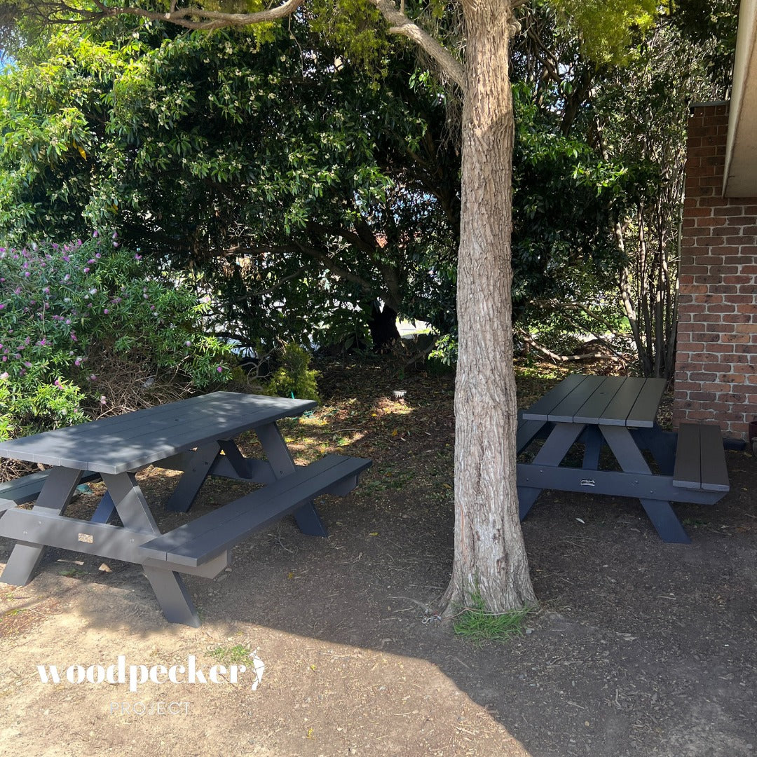 Functional picnic table crafted from pine and hardwood, offering comfortable seating for outdoor dining.