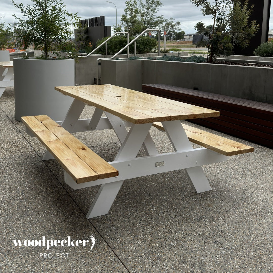 Crafted with rustic charm, this picnic table is ideal for backyard barbecues, offering a solid and inviting spot for guests to gather and indulge in delicious outdoor feasts.