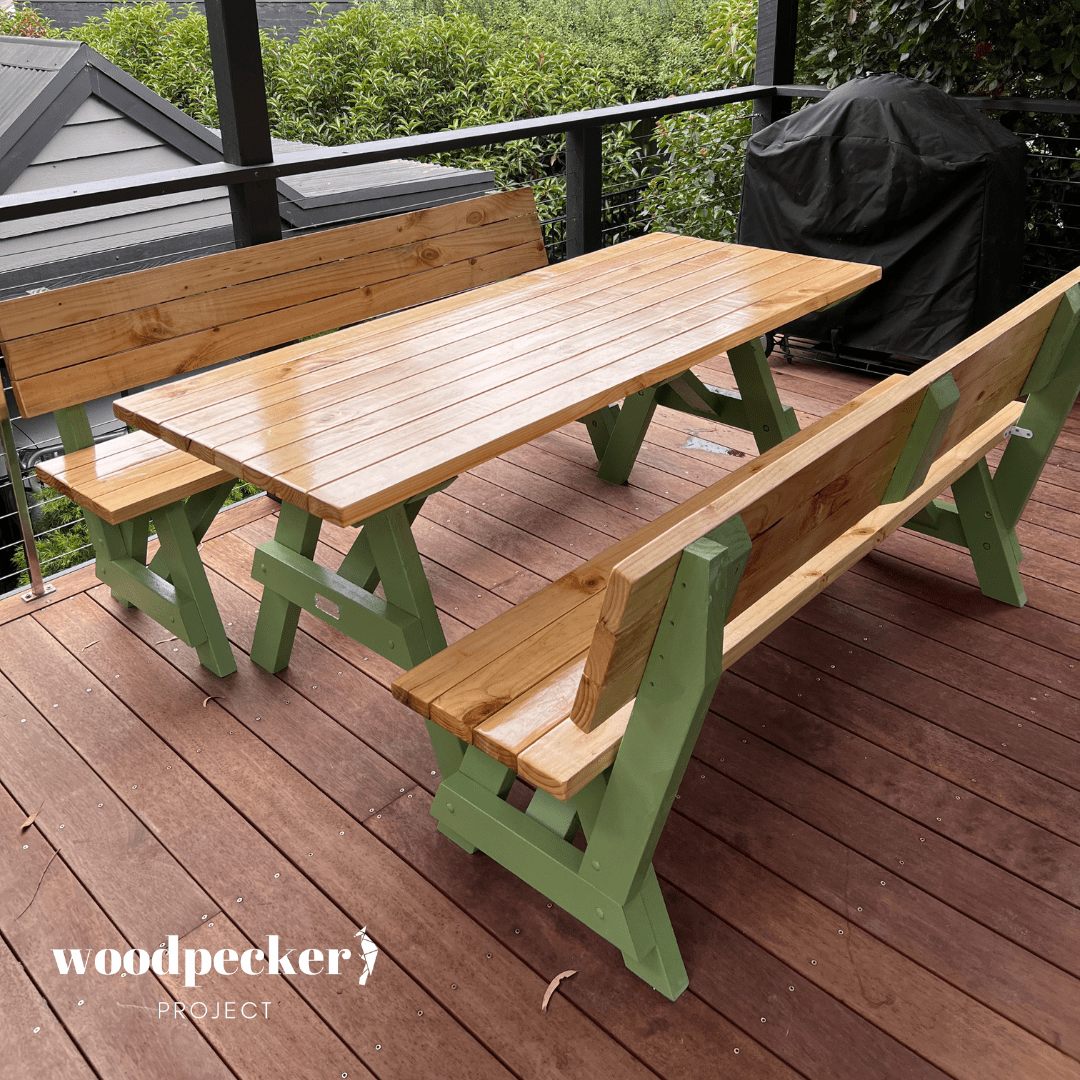 A modern picnic table set with sturdy wooden benches that have supportive backrests, ideal for enjoying long family gatherings in the garden