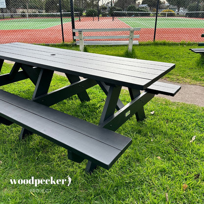 Weather-resistant picnic table crafted from pine and hardwood for year-round use.