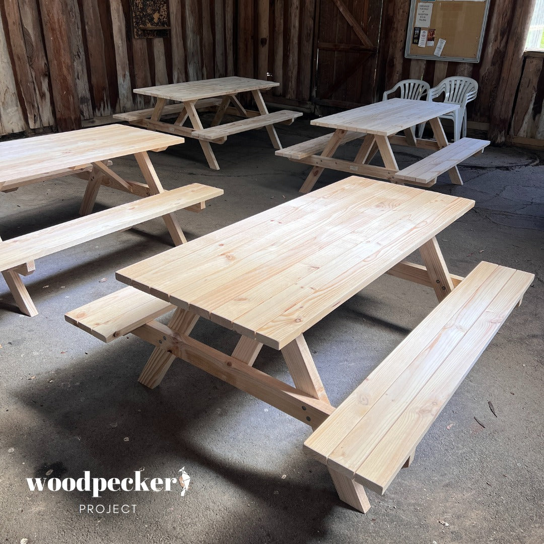 Natural wood picnic table set available for event hire, perfect for outdoor weddings and garden parties