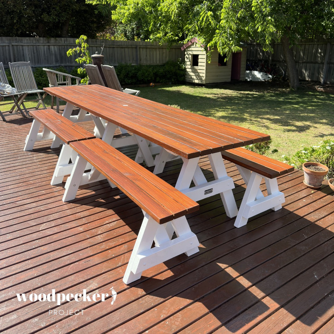 A rustic-style picnic table set made from high-quality timber, showcasing a natural wood grain finish, accompanied by two comfortable benches