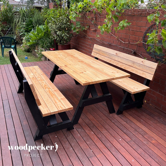 A beautifully crafted picnic table set with backrest-equipped benches, designed for ergonomic support and comfort during outdoor meals