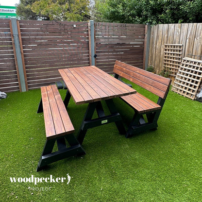 A spacious picnic table set with a sturdy wooden table and benches with backrests, ideal for hosting large outdoor gatherings and meals