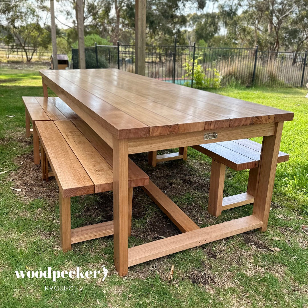 Experience the timeless elegance of a sturdy hardwood outdoor table, designed to withstand the elements and add rustic charm to your outdoor living space.