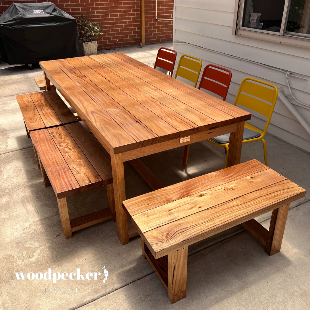 A solid hardwood outdoor table, crafted with durable timber, perfect for al fresco dining and entertaining in your backyard oasis.