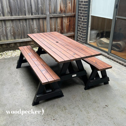 A contemporary picnic table set designed for outdoor use, featuring weather-resistant materials and a space-saving, separated bench design