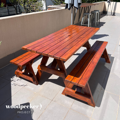 An eco-friendly picnic table set made from recycled wood, featuring a rustic charm and sturdy construction for outdoor dining