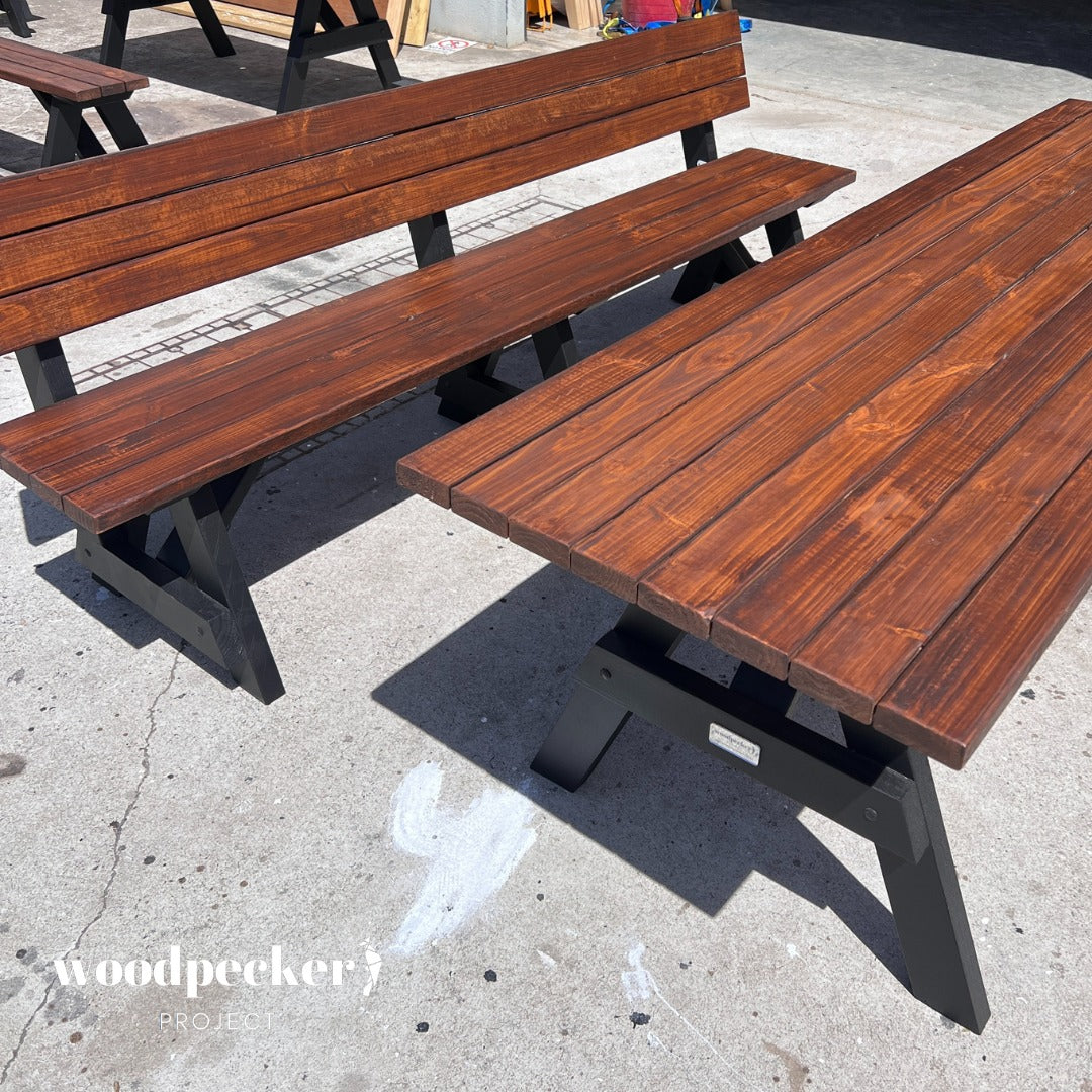 A beautifully designed picnic table set with a large table and separated benches that include comfortable backrests, ideal for relaxing in your garden