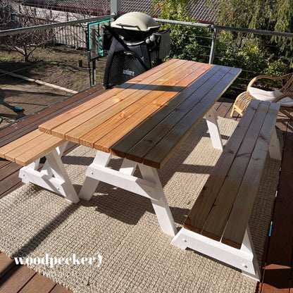 A charming picnic table set made from sustainably sourced wood, featuring a smooth finish and ergonomic benches for comfort