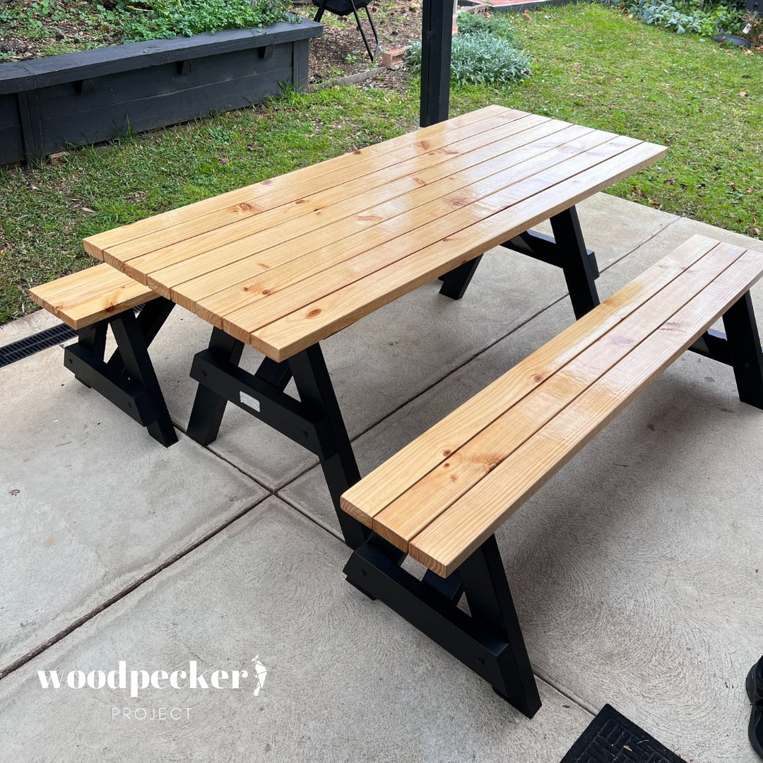 An elegant, handcrafted picnic table set with a durable wooden surface and detachable benches, ideal for family gatherings and backyard BBQs