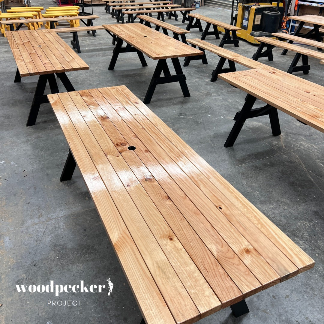 A premium outdoor picnic table set featuring a sleek, modern design with a robust wooden table and separated benches, perfect for stylish and functional alfresco dining experiences.