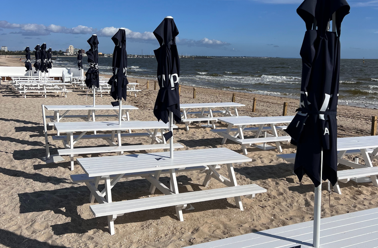 Outdoor white picnic table with detached benches